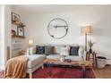 Cozy living room featuring a modern round mirror, decorative shelves, and a stylish coffee table at 799 Dahlia St # 503, Denver, CO 80220