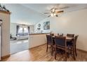 Cozy dining area adjacent to the living room with a wooden table and seating for six at 12425 Bellaire Dr, Thornton, CO 80241