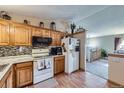 Efficient kitchen features wooden cabinets and modern appliances at 12425 Bellaire Dr, Thornton, CO 80241