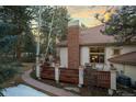 Backyard view of deck and wooded perimeter provides a private outdoor retreat on this property at 2828 Keystone Dr, Evergreen, CO 80439