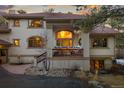 Charming front entry features flower boxes, rocking chair, and a large arched entryway with double doors at 2828 Keystone Dr, Evergreen, CO 80439
