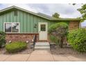 Exterior view of home with updated features including brick accents, new windows, and landscaping at 400 S Balsam St, Lakewood, CO 80226