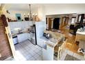 Functional kitchen with an eat-in breakfast bar, stainless steel refrigerator, and tile flooring at 1339 Quince St, Denver, CO 80220