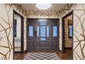 Welcoming entrance with a decorative glass door, hardwood floors, and access to elegantly designed rooms at 6483 S Prince St, Littleton, CO 80120