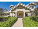 Inviting front entrance featuring an arched covered doorway and manicured hedges on either side of walkway at 6483 S Prince St, Littleton, CO 80120