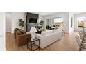 Open living room featuring natural light, sleek fireplace, and stylish decor at 7301 Canyon Sky Trl, Castle Pines, CO 80108