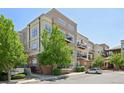Exterior shot of an apartment building with beige siding and multiple balconies and street parking at 5677 S Park Pl # 311A, Greenwood Village, CO 80111