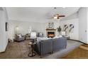 Cozy living room featuring a fireplace, neutral decor, and comfortable seating arrangement at 7040 Routt St, Arvada, CO 80004