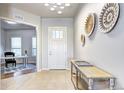 Bright entryway with decorative wall art, tile flooring, and a view into the living space at 365 Casalon Pl, Superior, CO 80027
