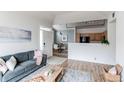 Open-concept living space flows into dining area, with stylish furnishings and ample natural light at 8500 E Jefferson Ave # 7B, Denver, CO 80237
