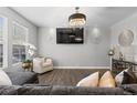 Bright living room with hardwood floors, large windows, modern light fixture, and stylish decor at 9758 Laredo St # 18D, Commerce City, CO 80022