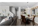 Open floor plan of living room and dining area with stylish decor, hardwood floors, and access to the kitchen at 9758 Laredo St # 18D, Commerce City, CO 80022