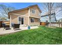Inviting backyard with patio, lush lawn, and comfortable outdoor seating arrangement at 12552 Tammywood St, Broomfield, CO 80020