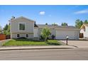 Charming two-story home with a well-manicured lawn, inviting curb appeal and a two car garage at 1043 Lilac Ct, Broomfield, CO 80020