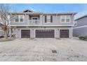 Exterior view of a multi-story townhome featuring three attached garages and second story balcony at 17271 Waterhouse Cir # A, Parker, CO 80134
