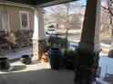 Inviting front porch with stone pillars and potted plants overlooking the street and neighborhood at 7456 E 10Th Ave, Denver, CO 80230