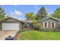 Charming brick home with a well-manicured front yard and an attached two-car garage at 3163 S Boston Ct, Denver, CO 80231