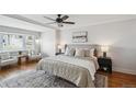 Relaxing bedroom showcases neutral tones, a ceiling fan, and large windows at 5990 W 8Th Ave, Lakewood, CO 80214