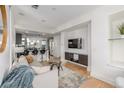 Open-concept living room with seamless flow to the modern kitchen and breakfast bar at 2758 W 22Nd Ave, Denver, CO 80211
