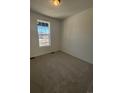 Bright bedroom with neutral carpeting and large window at 5127 N Quemoy St, Aurora, CO 80019