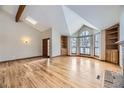 Bright living room with hardwood floors, vaulted ceiling, built-in shelves, and fireplace at 223 Durham Ct, Castle Pines, CO 80108