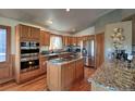 Spacious kitchen with stainless steel appliances and granite countertops at 10197 Crest View Dr, Morrison, CO 80465