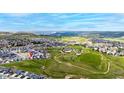 Expansive aerial view showing the neighborhood, surrounding green space, and mountain views in the distance at 2060 Peralta Loop, Castle Rock, CO 80104