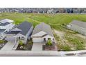 An aerial view of a well-maintained home with a two car garage, landscaping, and a charming front porch at 2060 Peralta Loop, Castle Rock, CO 80104