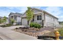 Beautiful home exterior featuring a stone accent wall, a well-manicured yard, and a charming front porch at 2060 Peralta Loop, Castle Rock, CO 80104