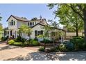 Charming two-story home with lush landscaping, a circular driveway, and inviting curb appeal at 3500 S Franklin St, Englewood, CO 80113