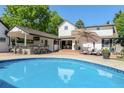 Backyard pool with an outdoor kitchen, bar seating, and patio furniture at 3500 S Franklin St, Englewood, CO 80113
