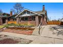 Inviting brick home with a well-kept yard and a convenient side driveway at 3345 W Clyde Pl, Denver, CO 80211