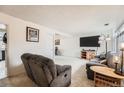 Cozy living room featuring plush seating, neutral carpet, and ample space for relaxation and entertainment at 12407 E Louisiana Ave, Aurora, CO 80012