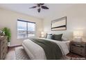 Well-lit bedroom with a large window, comfortable bed, and stylish decor at 10111 Inverness Main St # 228, Englewood, CO 80112