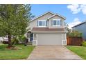 Charming two-story home with a well-manicured lawn, gray siding, and a two-car garage at 7888 Canvasback Cir, Littleton, CO 80125