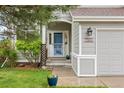 Close-up of front entrance with decorative shrubbery and a clear view of the house number at 7888 Canvasback Cir, Littleton, CO 80125