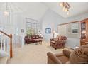Bright living room featuring large windows, neutral carpets, and comfortable seating at 7888 Canvasback Cir, Littleton, CO 80125