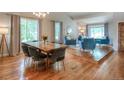 Bright open concept living and dining room with hardwood floors and large windows at 8140 S Storm King Peak, Littleton, CO 80127
