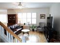 Inviting living room with hardwood floors, a leather sofa, and abundant natural light at 11883 E Fair Ave, Greenwood Village, CO 80111