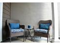 Cozy patio seating area with wicker chairs and a small accent table at 11883 E Fair Ave, Greenwood Village, CO 80111