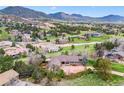 A charming home nestled in a lush landscape with picturesque mountain views, surrounded by mature trees and a tranquil setting at 6093 Willowbrook Dr, Morrison, CO 80465