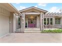 Inviting front entrance with a colorful door, stone walkway, and charming pergola, perfect for welcoming guests at 6093 Willowbrook Dr, Morrison, CO 80465