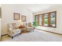 Cozy sitting room with natural light from large windows, comfortable armchairs, and stylish decor creating a relaxing atmosphere at 6093 Willowbrook Dr, Morrison, CO 80465