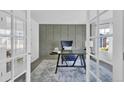 Elegant home office featuring wainscotting, neutral carpet, large desk, and a large window that provides natural light at 275 S Pembrook St, Castle Rock, CO 80104