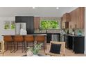 Modern kitchen featuring sleek black cabinets, stainless steel appliances, and a stylish breakfast bar with seating at 4269 Carter Trl, Boulder, CO 80301