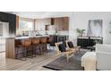 Modern kitchen featuring a spacious island with seating, sleek cabinets, and a built-in wine cooler at 4269 Carter Trl, Boulder, CO 80301