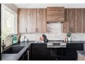 Well-designed kitchen showcasing walnut cabinets, black counters, and stainless-steel appliances at 4269 Carter Trl, Boulder, CO 80301