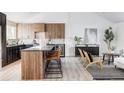 Modern kitchen featuring a spacious island with seating, sleek cabinets, and a built-in wine cooler at 4269 Carter Trl, Boulder, CO 80301
