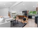 Bright and airy living room open to the kitchen with stainless appliances and a center island with barstool seating at 4269 Carter Trl, Boulder, CO 80301