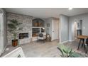 Bright and airy living room with a fireplace, built-in shelving, and an open doorway at 11645 Lincoln St, Northglenn, CO 80233